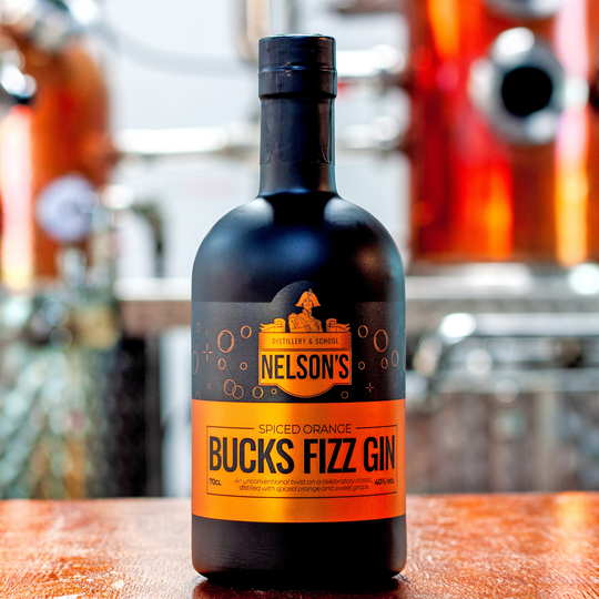 Nelson's Bucks Fizz Gin in front of blurred background of Nelson's 150L Alembic Still, Victory.