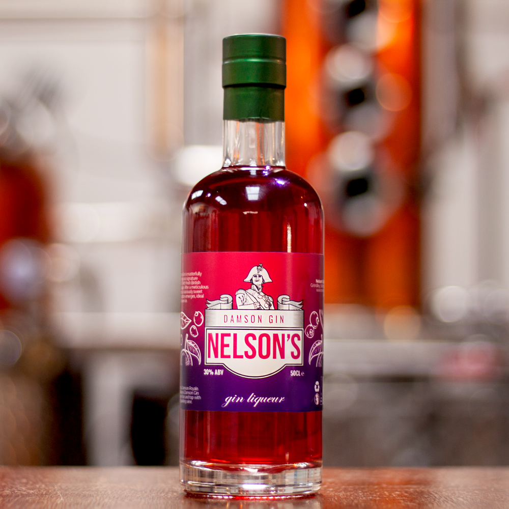 Nelson's Damson Gin Liqueur in front of blurred background of Nelson's 150L Alembic Still, Victory.